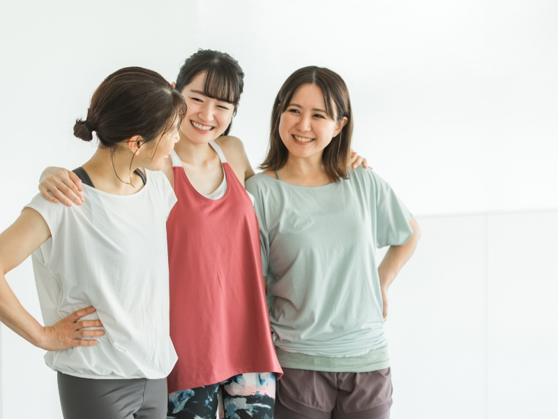 Women conversing at a fitness center.